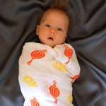 Baby wrapped in a chinese patterned fan and lantern for luck & love muslin swaddle