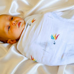 Baby wrapped in a rainbow cockatoo muslin swaddle australia LGBTQI Gay love